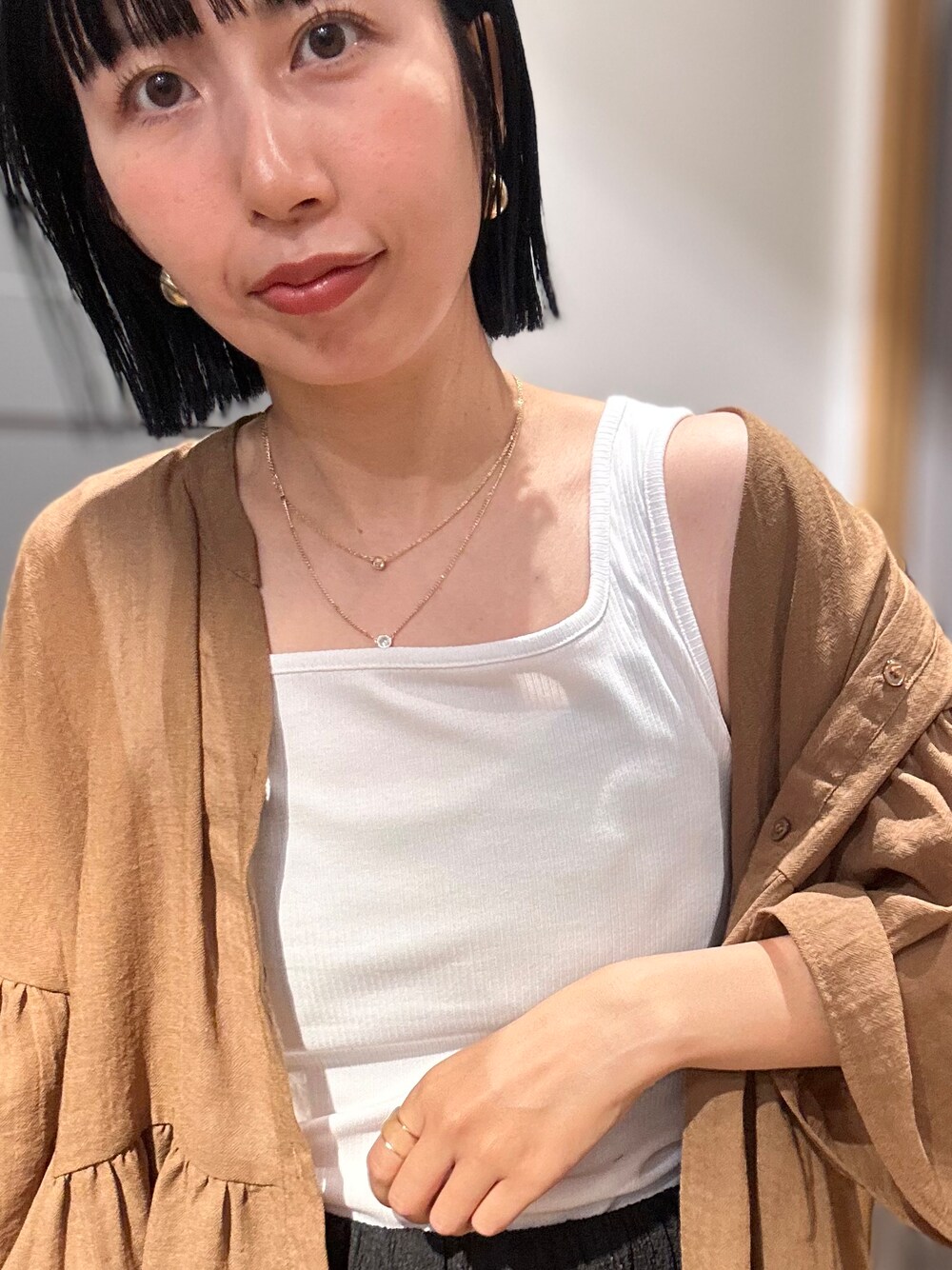 ブラウン系のシャツ/ブラウス、ホワイト系のタンクトップ、ブラック系のその他パンツを着用したレディースの夏コーディネートの6枚目の写真