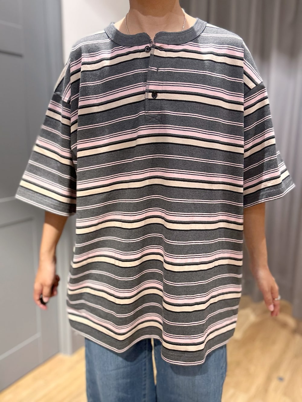 グレー系のTシャツ/カットソー、ブルー系のデニムパンツ、ベージュ系のトートバッグを着用したレディースの夏コーディネートの4枚目の写真