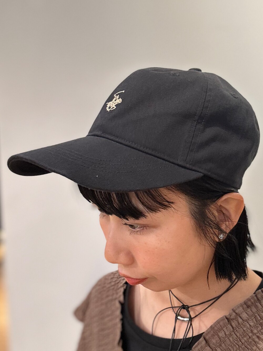 ブルー系のデニムパンツ、ブラック系のキャップを着用したレディースの夏コーディネートの8枚目の写真
