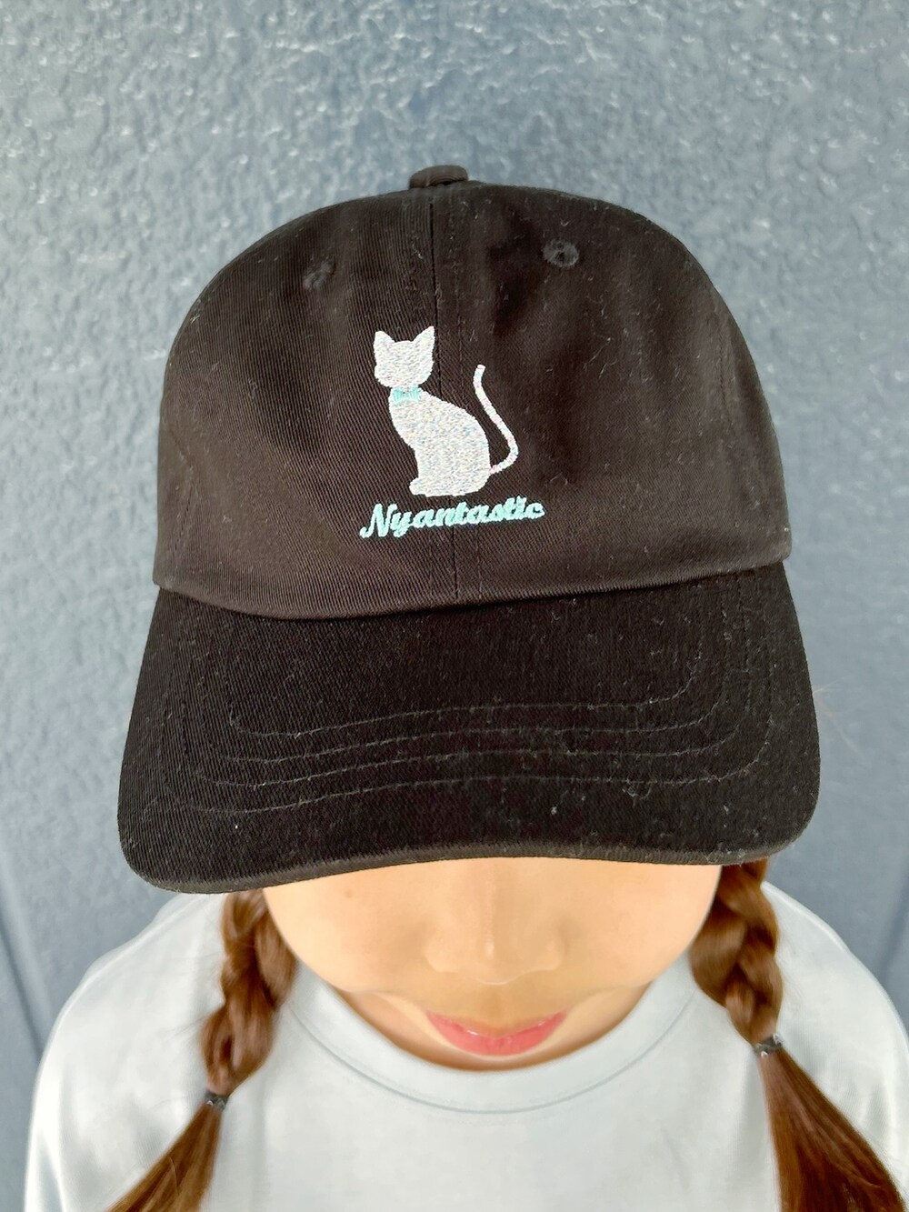 ブルー系のTシャツ/カットソー、ブラック系のデニムパンツ、ブラック系のキャップを着用したレディースの春コーディネートの7枚目の写真