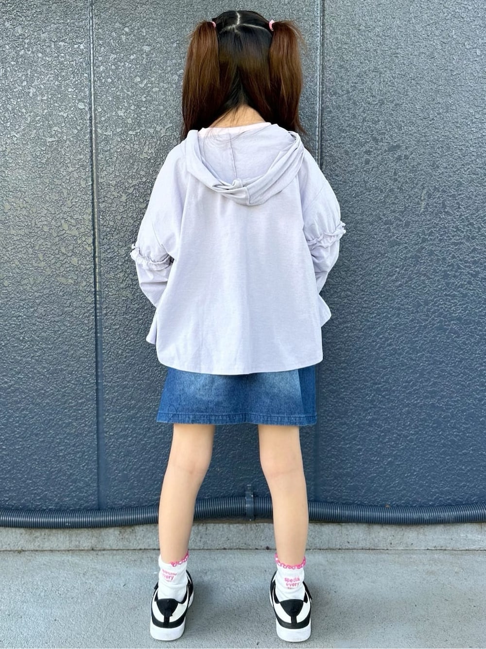 ピンク系のTシャツ/カットソー、ブルー系のデニムスカート、パープル系のパーカーを着用したキッズの春コーディネートの3枚目の写真