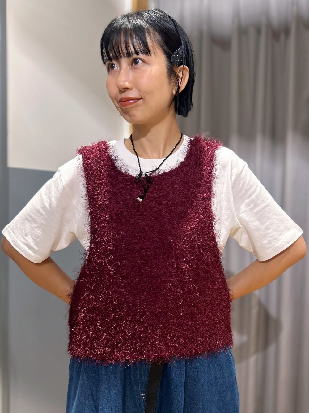 ホワイト系のTシャツ/カットソー、レッド系のベスト、ブルー系のその他パンツを着用したレディースの秋コーディネートの4枚目の写真