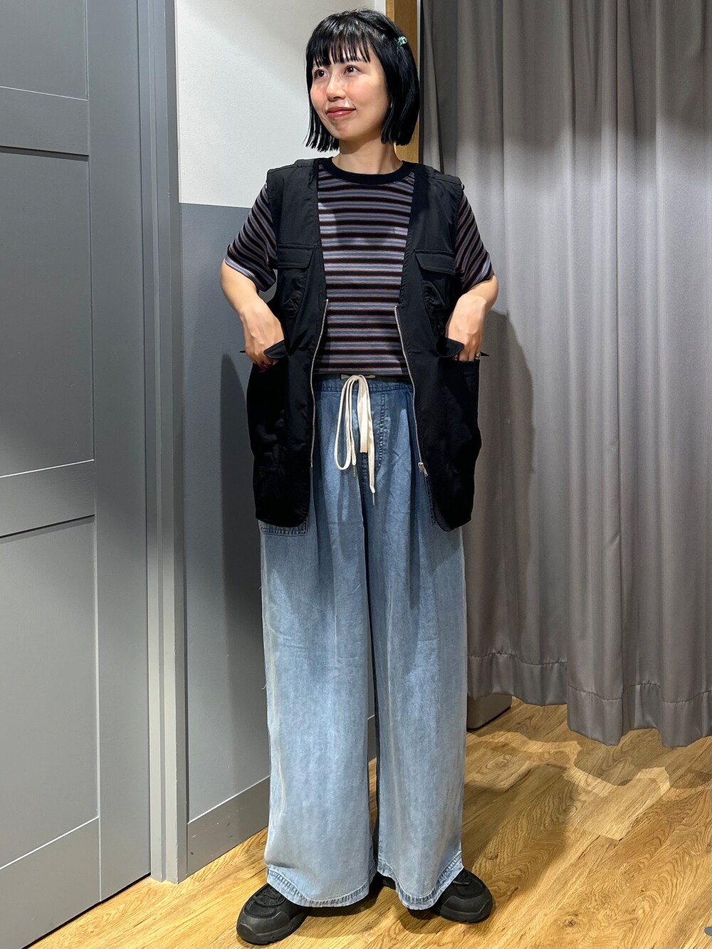 ブルー系のTシャツ/カットソー、ブラック系のシャツ/ブラウス、ブルー系のデニムパンツを着用したレディースの夏コーディネートの2枚目の写真