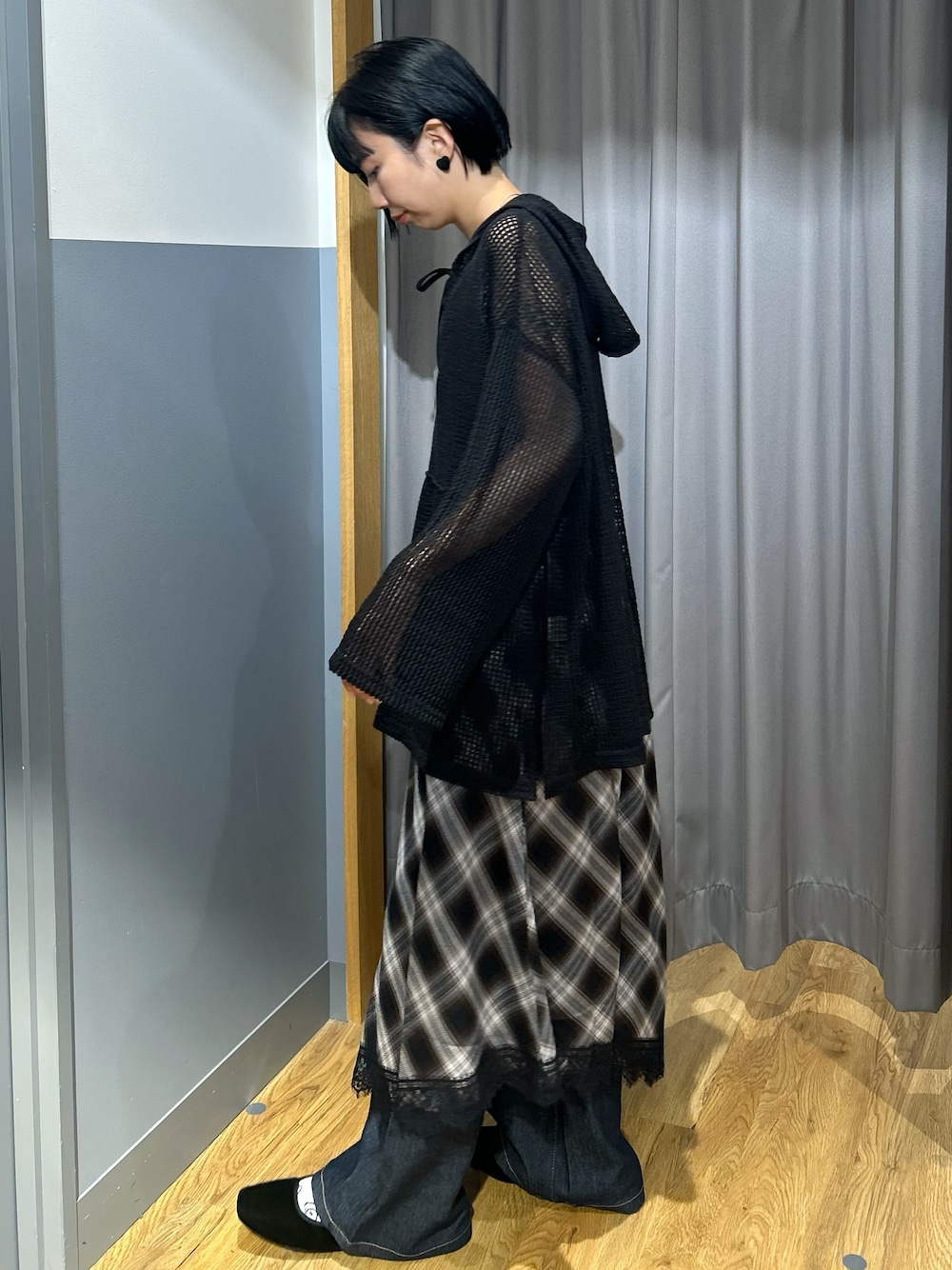 ブラウン系のタンクトップ、ブラック系のTシャツ/カットソー、ブラック系のスカートを着用したレディースの秋コーディネートの2枚目の写真
