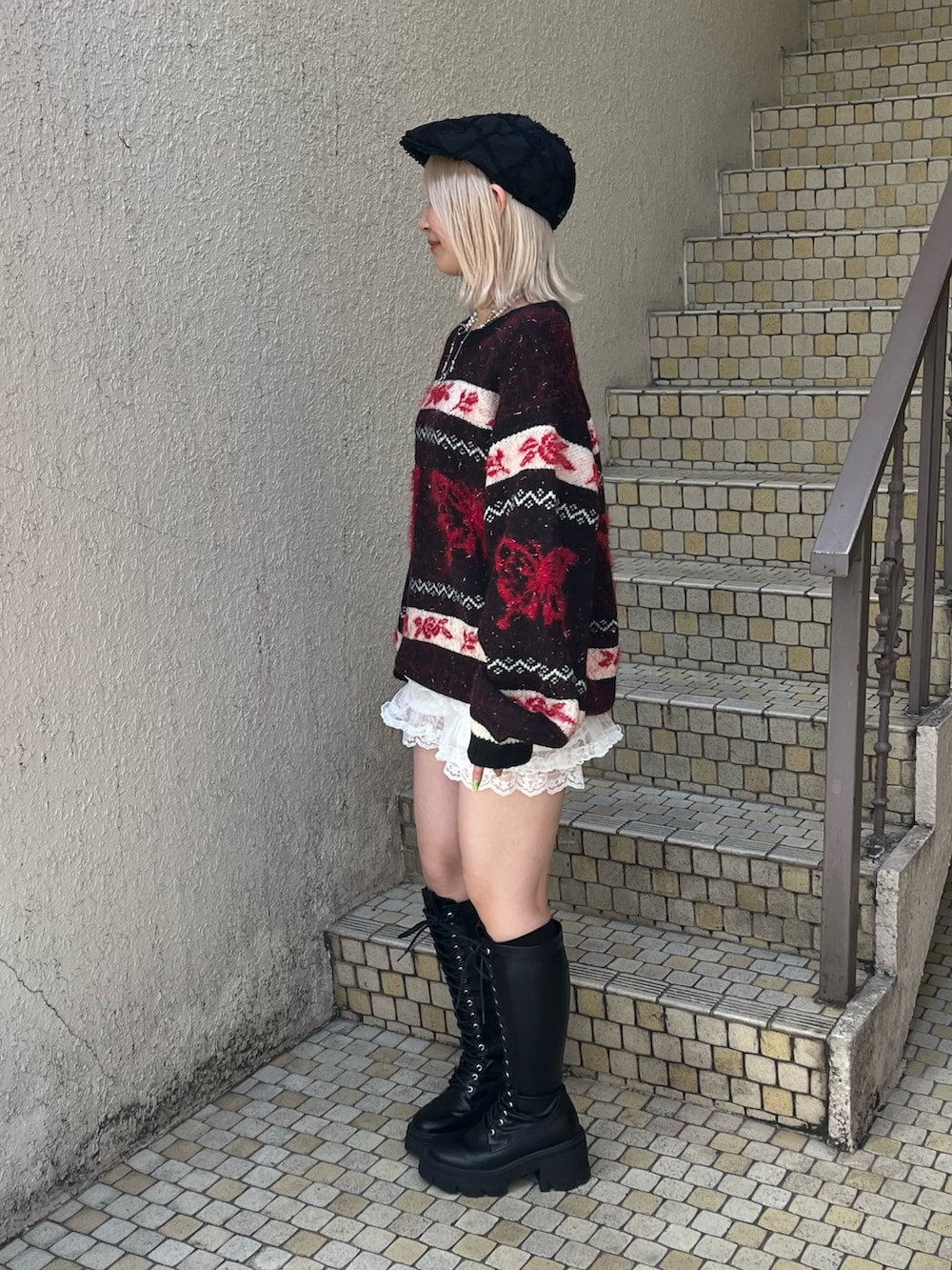 ブラック系のニット/セーター、ホワイト系のその他パンツ、ブラック系のブーツを着用したレディースの秋コーディネートの4枚目の写真