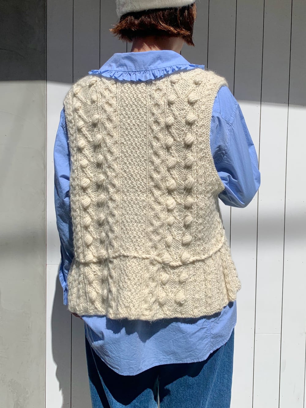 ホワイト系のベスト、ブルー系のシャツ/ブラウス、ブルー系のデニムパンツを着用したレディースの秋コーディネートの5枚目の写真