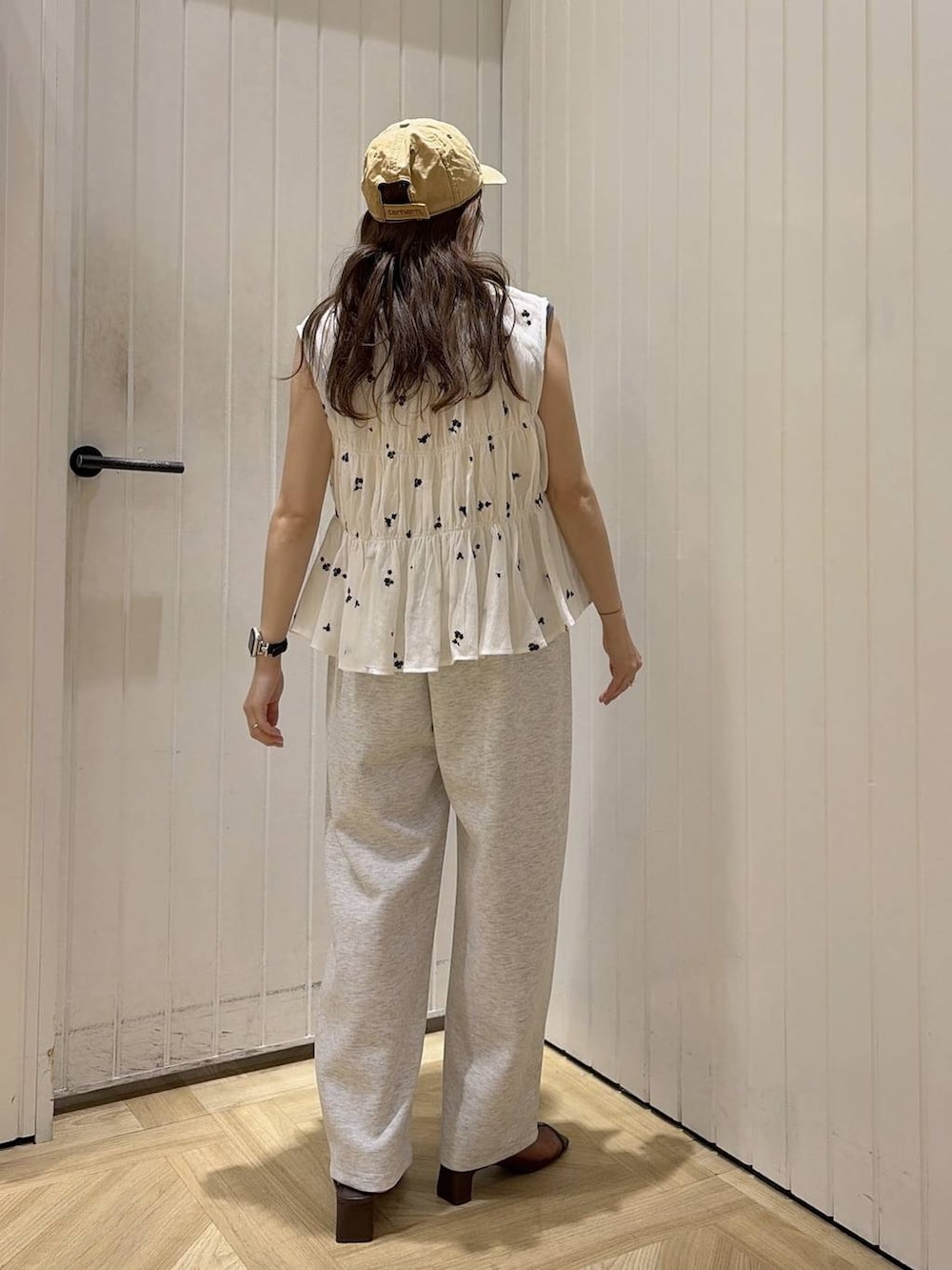グレー系のスウェットパンツ、ピンク系のタンクトップ、ブラウン系のサンダルを着用したレディースの夏コーディネートの3枚目の写真