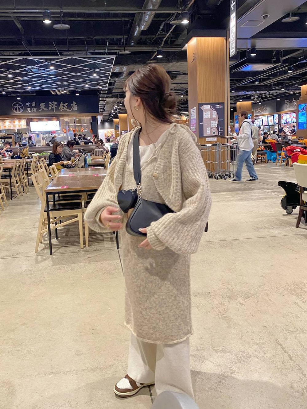 ホワイト系のワンピース、ホワイト系のタンクトップ、ブラック系のショルダーバッグを着用したレディースの秋コーディネートの4枚目の写真