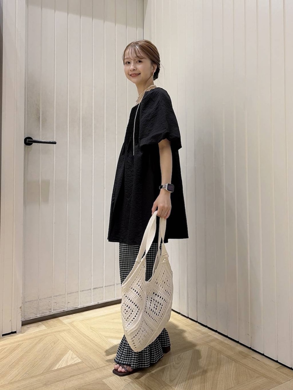 ブラック系のシャツ/ブラウス、ブラウン系のサンダル、ホワイト系のトートバッグを着用したレディースの夏コーディネートの3枚目の写真