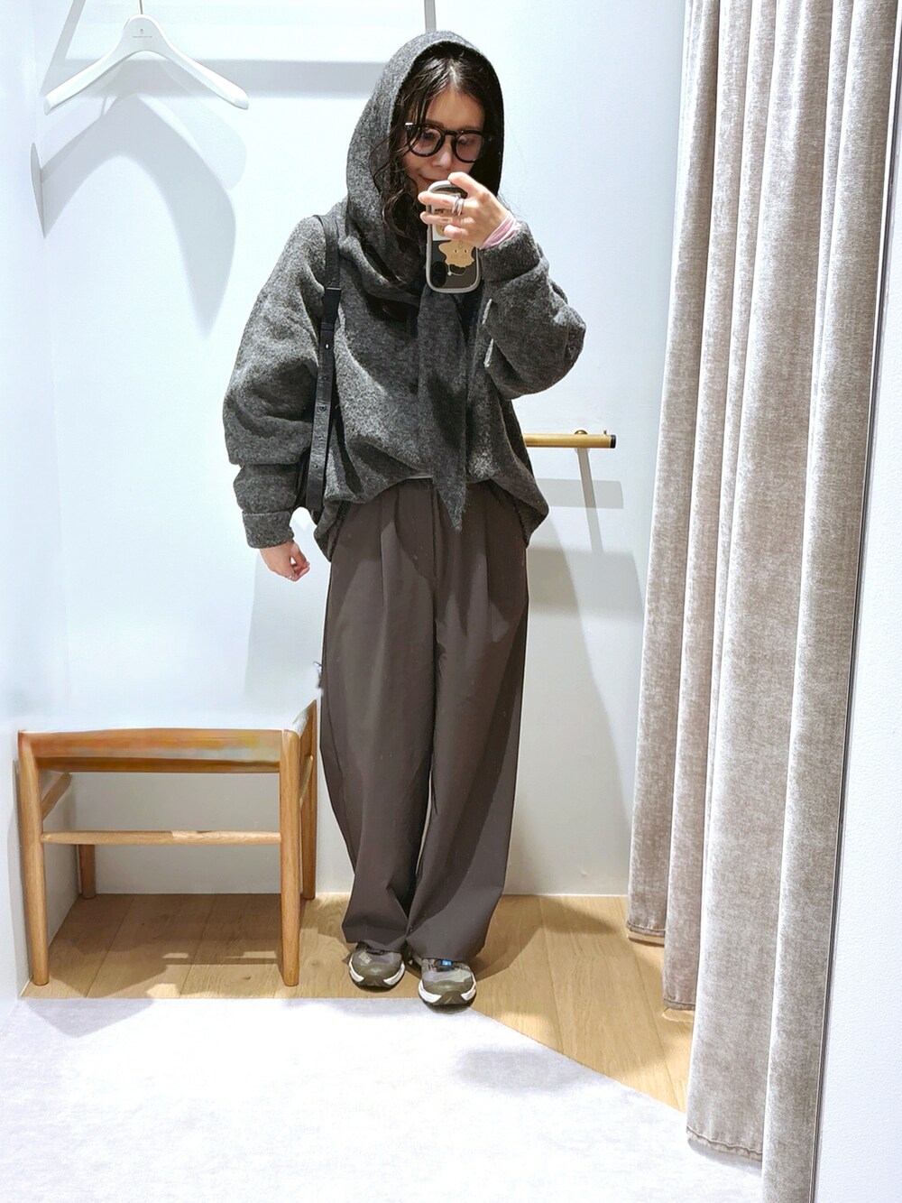 グレー系のニット/セーター、グレー系のスラックス、グレー系のスニーカーを着用したレディースの冬コーディネートの2枚目の写真