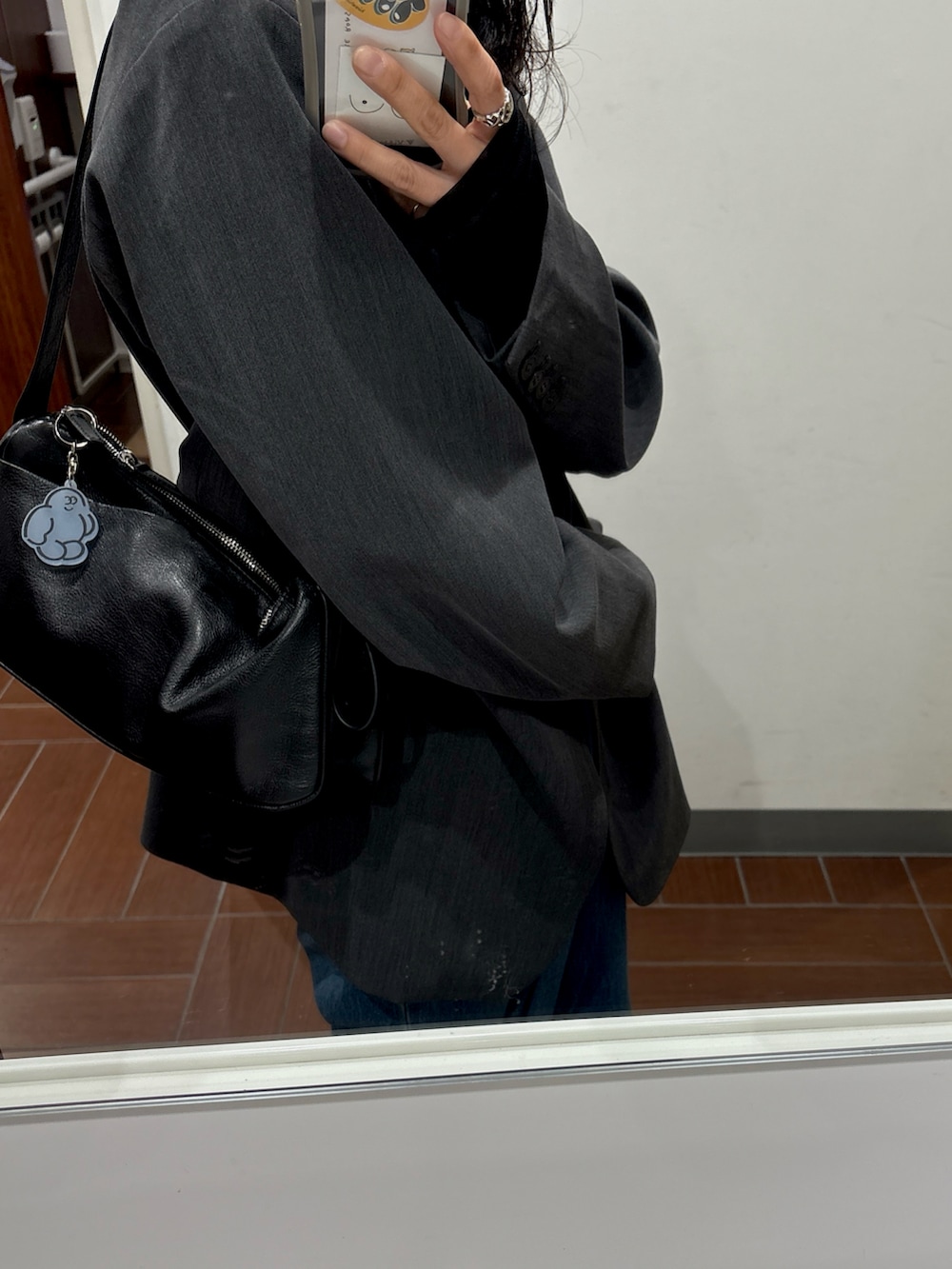 ブラック系のシャツ/ブラウス、グレー系のテーラードジャケット、ブルー系のデニムパンツを着用したレディースの春コーディネートの2枚目の写真