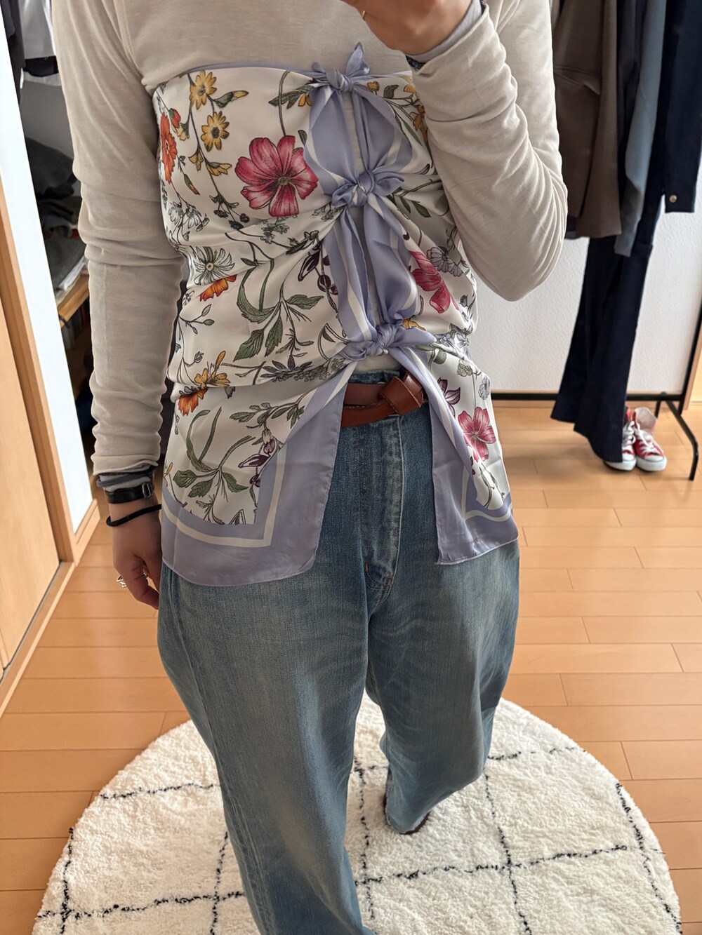 ブルー系のデニムパンツ、ブラウン系のテーラードジャケット、その他のハンドバッグを着用したレディースの春コーディネートの3枚目の写真