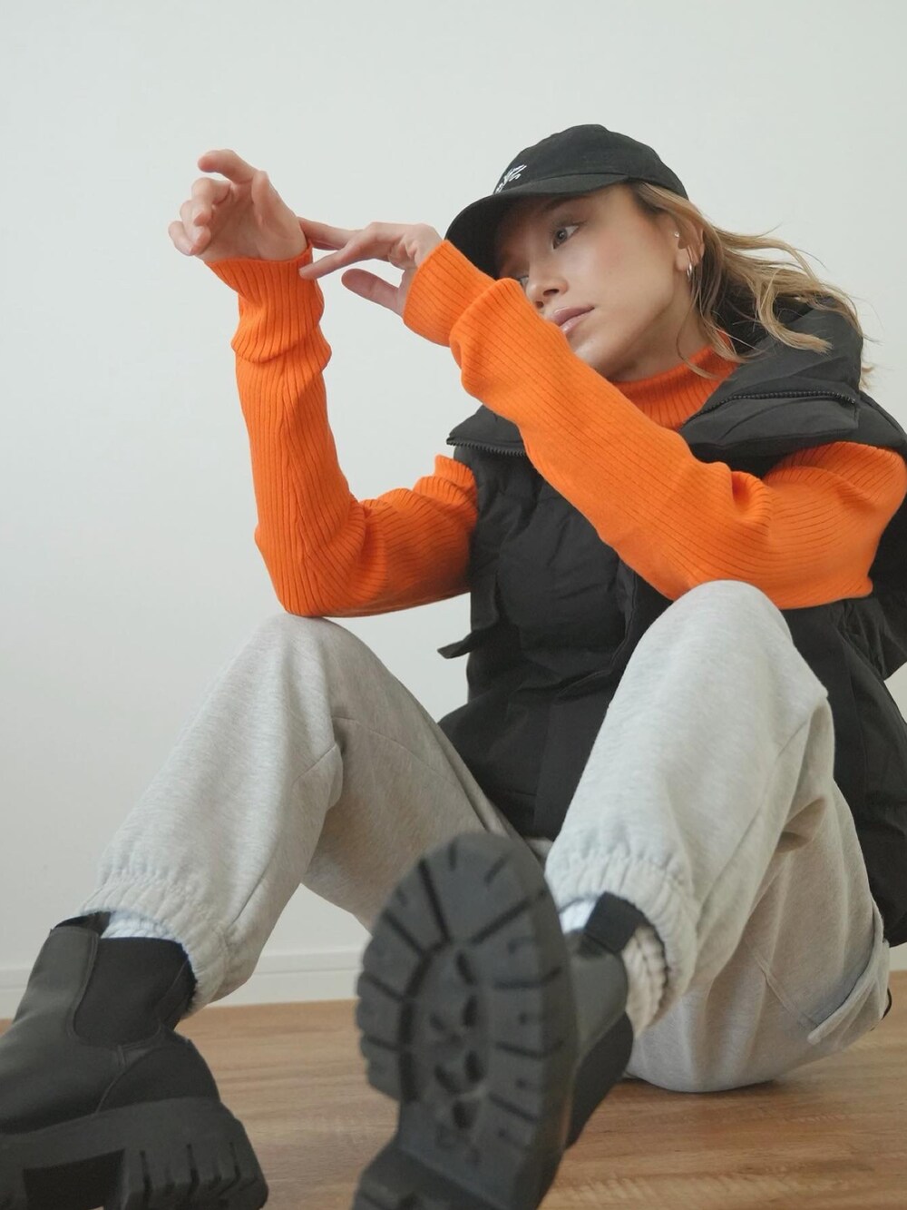 「冬コーデ、ストリート、カラーニット、オレンジ、ハイネック、ダウンベスト、スウェットパンツ、オトナ女子、大人コーデ、ブラック、ラフ、キャップ、パンツスタイル、リラックススタイル、ストリートコーデ」｜「Sun Vivianのアイテム（キャップ、ブラック系）」を使った、階上実穂さん（骨格ナチュラル・レディース・158cm）の冬コーディネートの4枚目の写真
