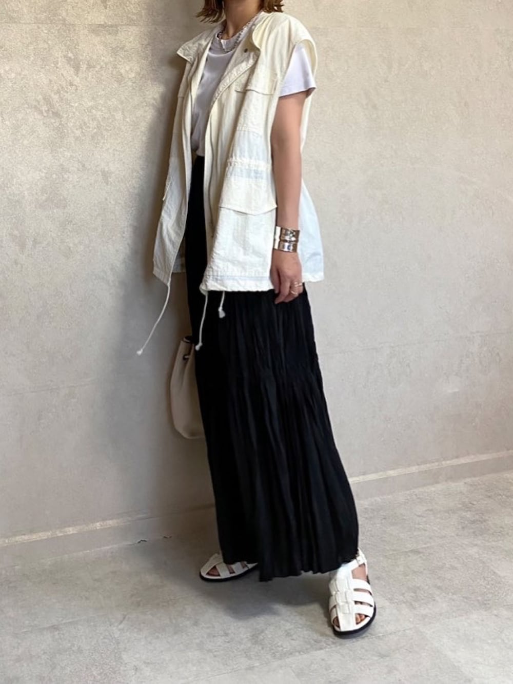 「モノトーン、モノトーンコーデ、ベスト、ベストコーデ、ベストスタイル、ベスト×Tシャツ、白Tシャツ、ロングスカート、ワッシャースカート、巾着バッグ、レザーバッグ、vitafelice、グルカサンダル、シンプル、カジュアルコーデ」｜「w closetのスタンドネックドロップショルダーミリタリーベスト（ミリタリージャケット、ホワイト系）」を使った、miho🅰ニコさん（レディース・165cm）の夏コーディネートの2枚目の写真