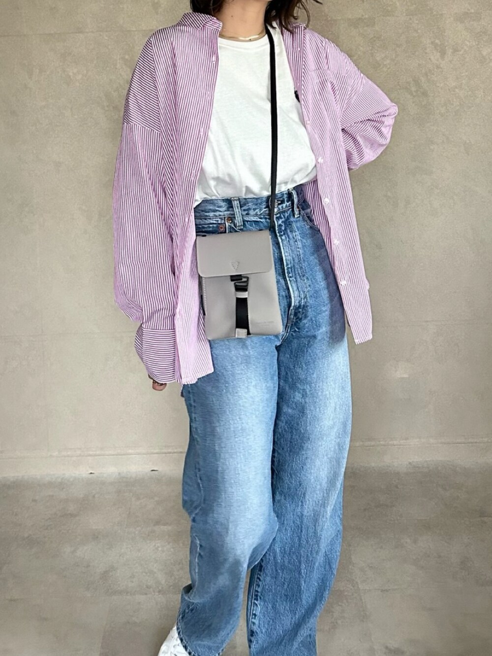 ピンク系のシャツ/ブラウス、グレー系のバッグ、ホワイト系のTシャツ/カットソーを着用したレディースの春コーディネートの4枚目の写真