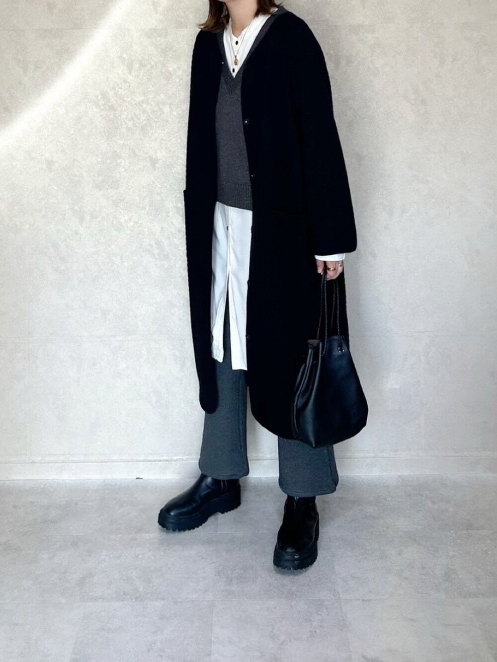 グレー系のその他パンツ、ブラック系のショルダーバッグ、ブラック系のその他アウターを着用したレディースの冬コーディネートの3枚目の写真
