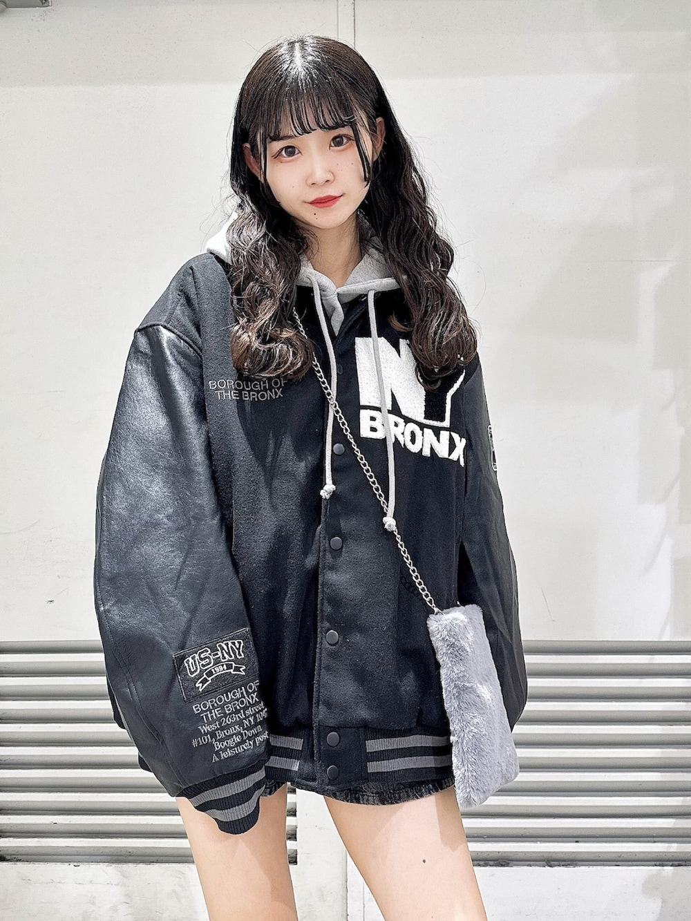 ブラック系のブーツ、グレー系のショルダーバッグ、ブラック系のスタジャンを着用したレディースの冬コーディネートの3枚目の写真