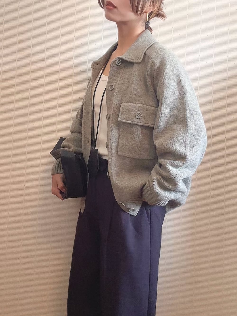 グリーン系のジャケット/アウター、ブラック系のハンドバッグ、ブラック系のパンツを着用したレディースの秋コーディネートの2枚目の写真