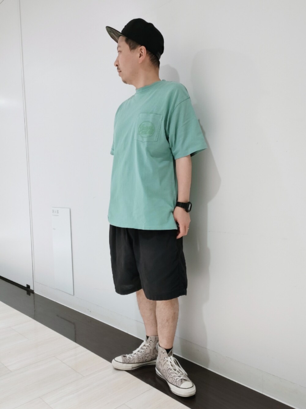 グリーン系のTシャツ/カットソー、ブラック系のその他パンツ、ブラック系のキャップを着用したメンズの夏コーディネートの2枚目の写真