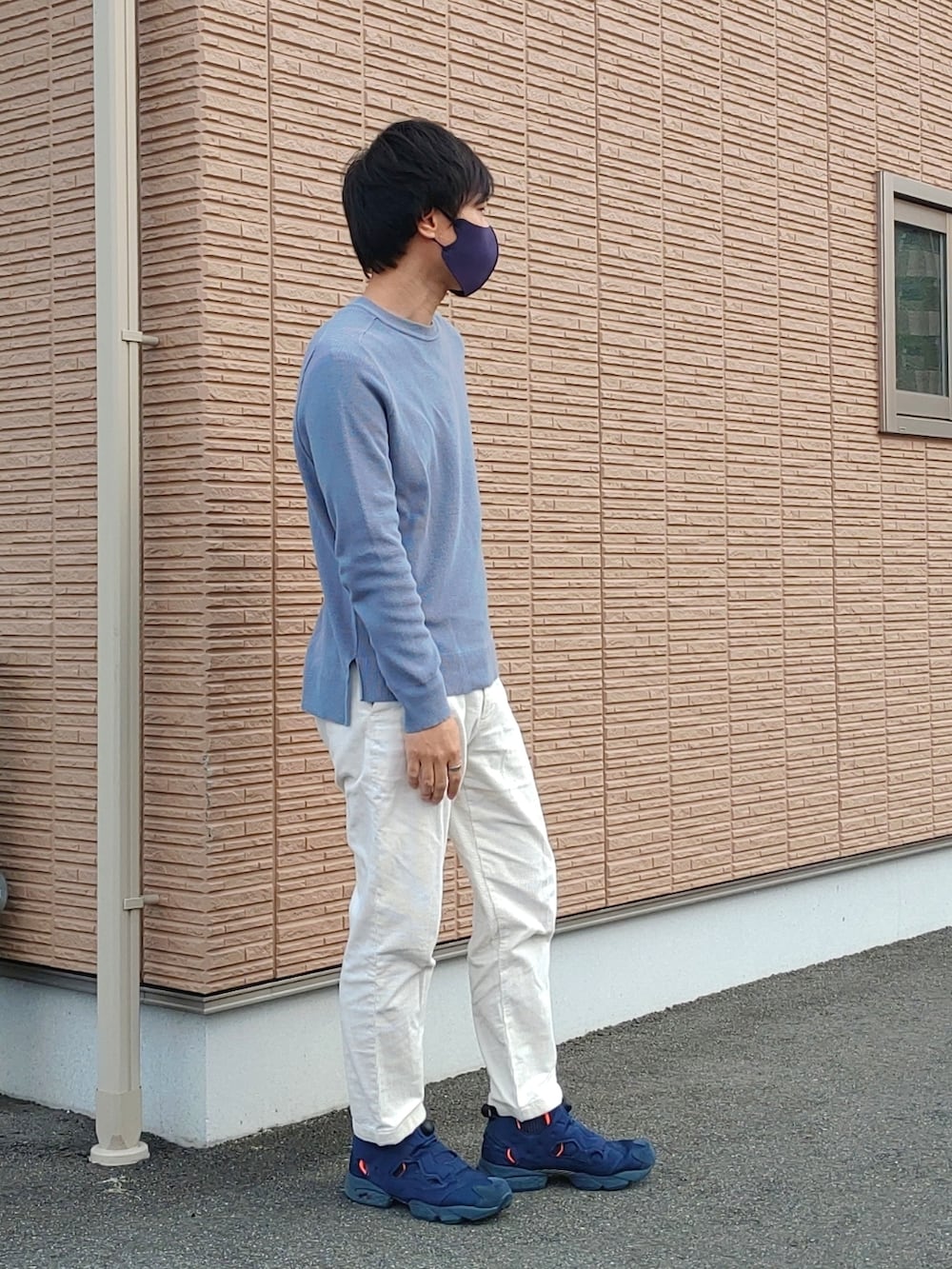 ブルー系のニット/セーター、ホワイト系のその他パンツ、ブルー系のスニーカーを着用したメンズの春コーディネートの2枚目の写真