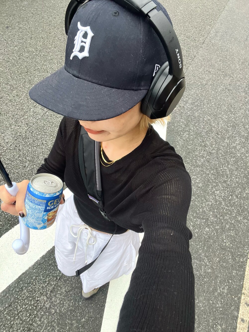 ブラック系のTシャツ/カットソー、ホワイト系のパンツ、グレー系のスニーカーを着用したレディースの夏コーディネートの2枚目の写真