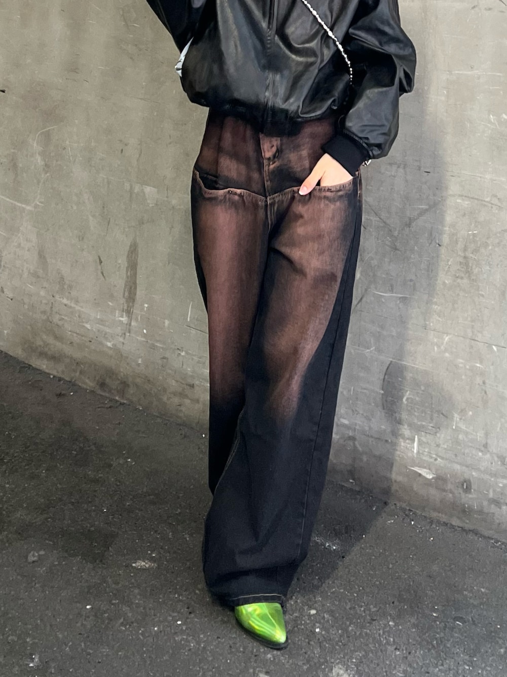 ブルー系のデニムパンツ、ブラック系のブーツ、シルバー系のショルダーバッグを着用したレディースの冬コーディネートの2枚目の写真