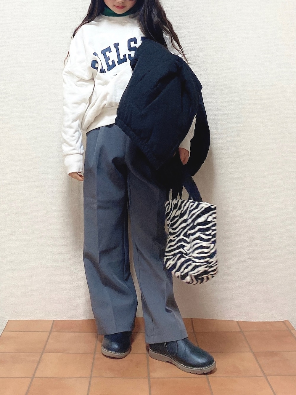 ブラック系のダウンジャケット/コート、ホワイト系のスウェット、グレー系のスラックスを着用したキッズの冬コーディネートの2枚目の写真