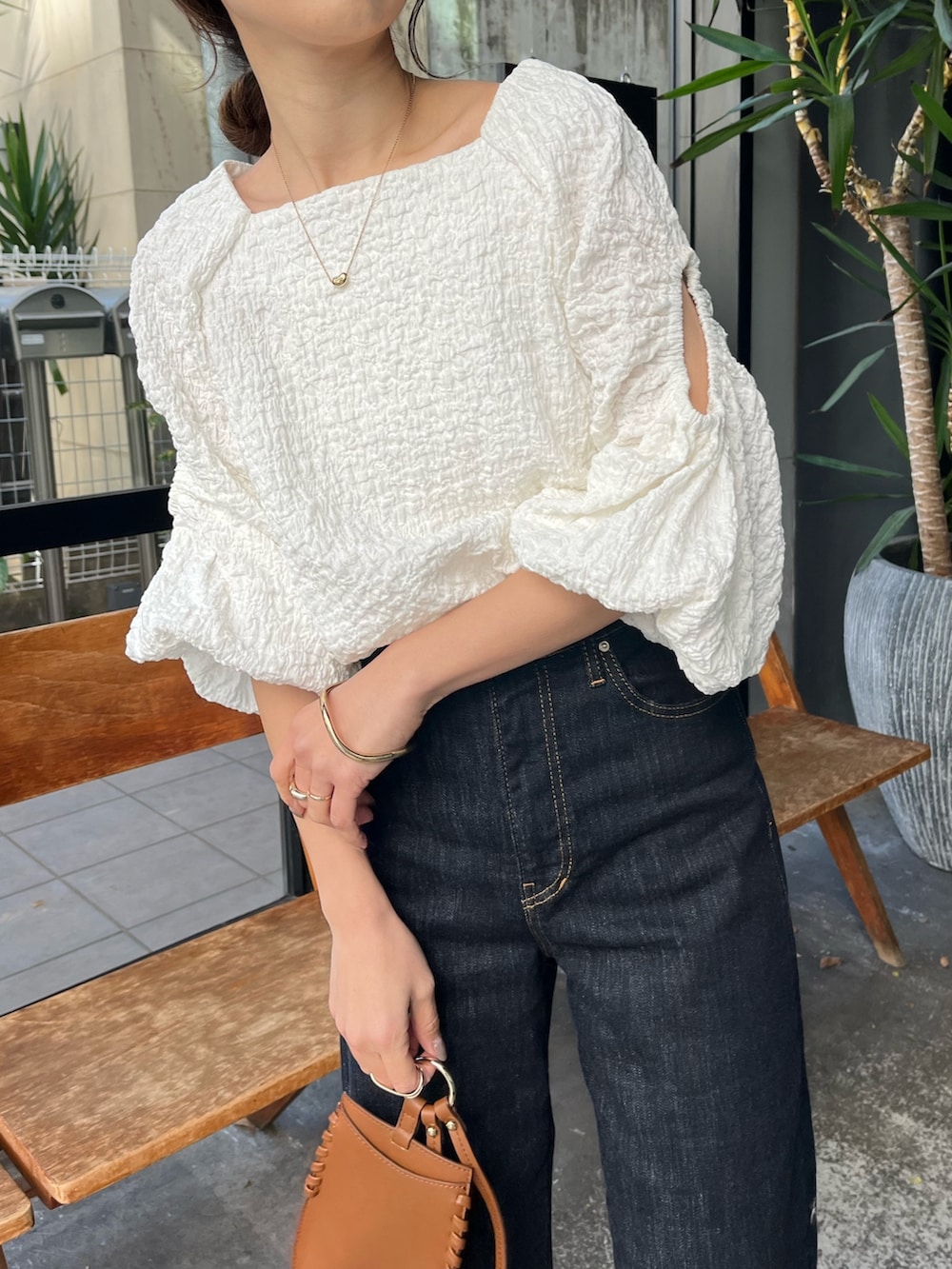 ブラック系のサンダル、ホワイト系のシャツ/ブラウス、ブルー系のデニムパンツを着用したレディースの春コーディネートの4枚目の写真