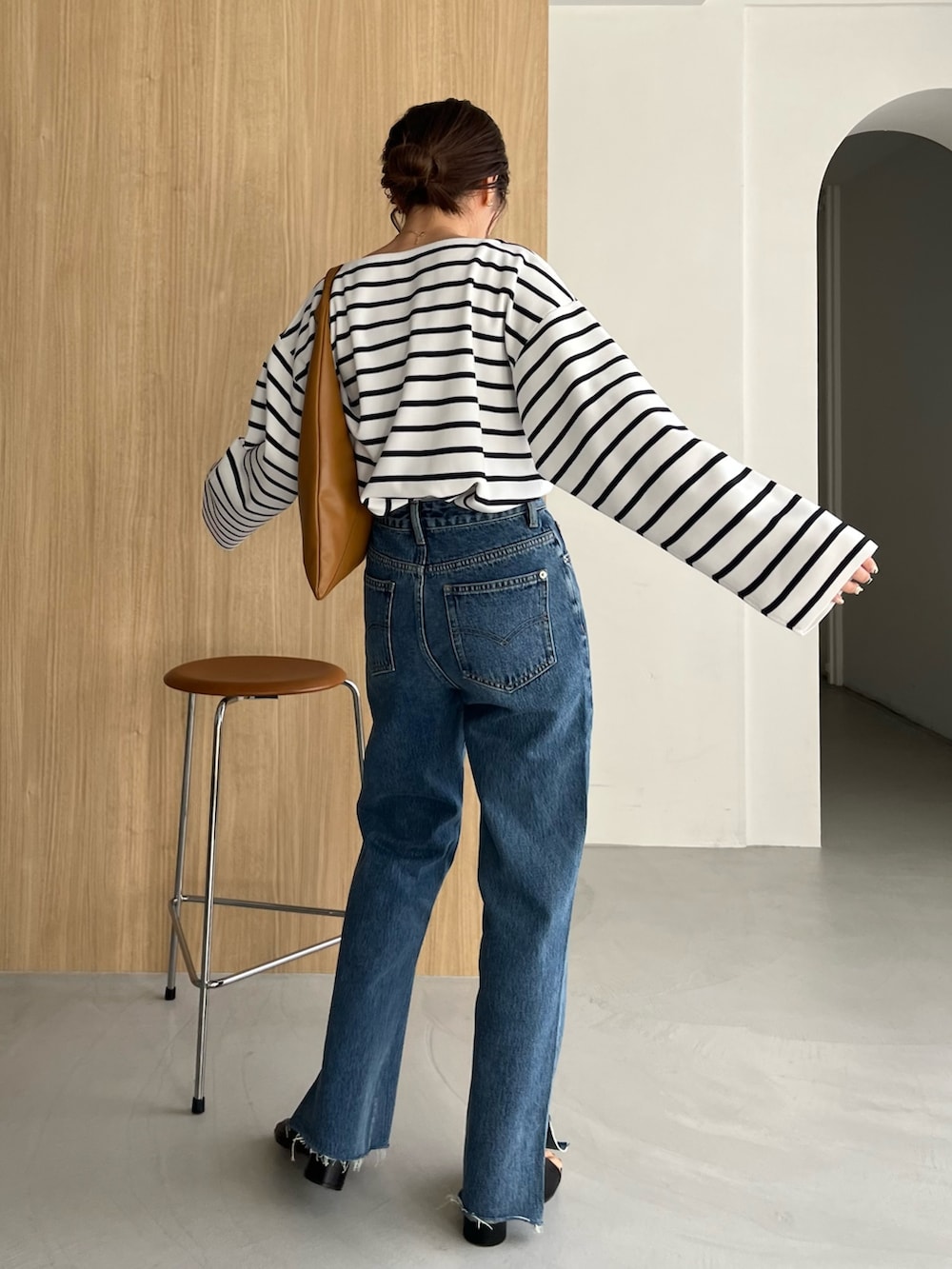 ホワイト系のニット/セーター、ブルー系のデニムパンツ、ブラック系のサンダルを着用したレディースの冬コーディネートの3枚目の写真