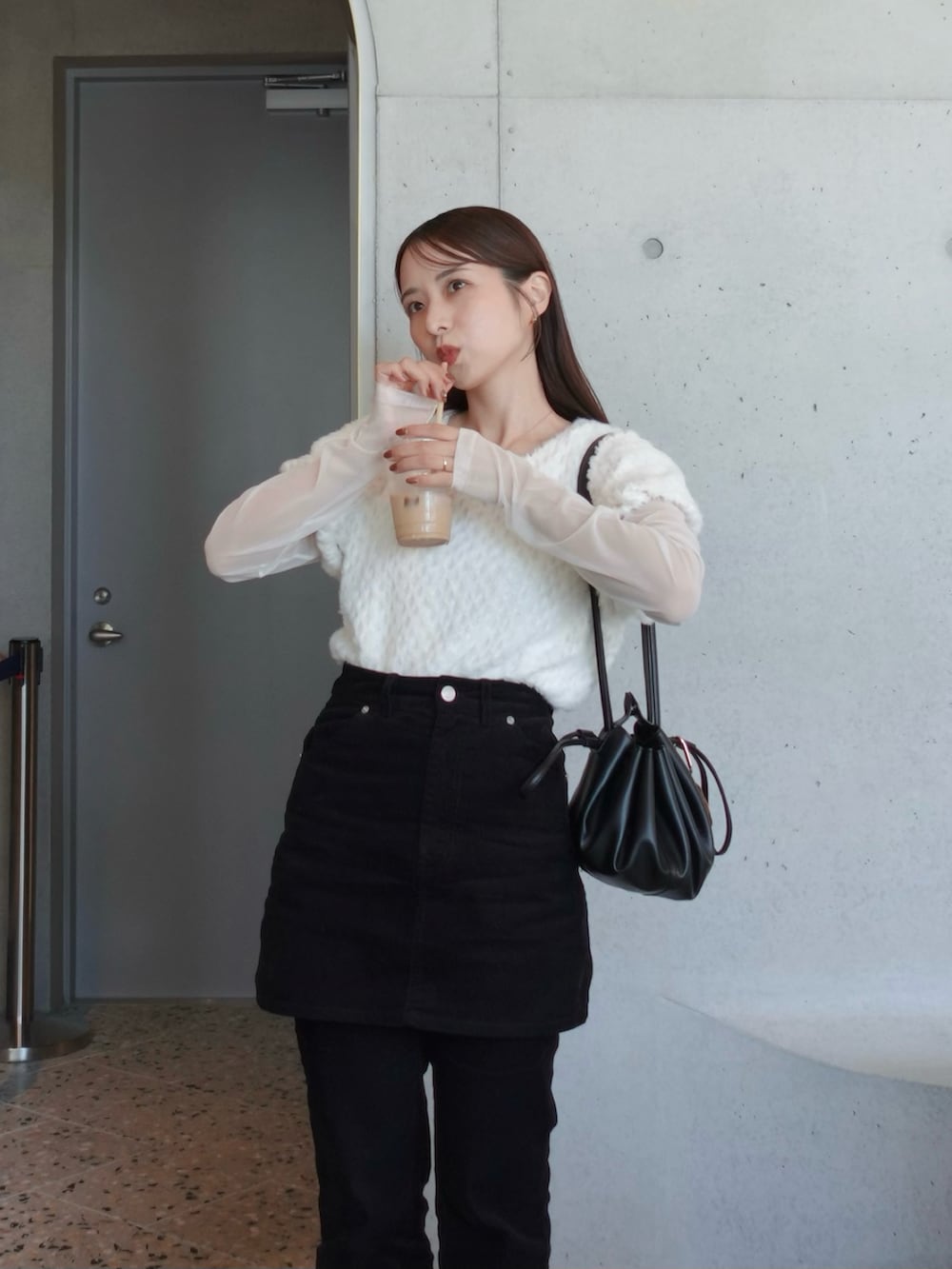 ブラック系のその他パンツ、ブラック系のスカート、ブラック系のショルダーバッグを着用したレディースの秋コーディネートの2枚目の写真