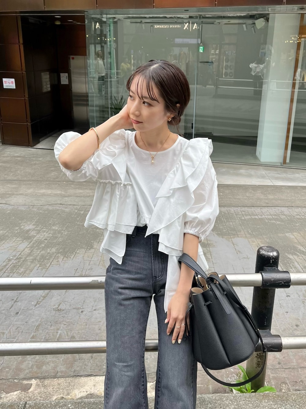 ホワイト系のシャツ/ブラウス、ブラック系のバッグ、ブラック系のサンダルを着用したレディースの春コーディネートの3枚目の写真