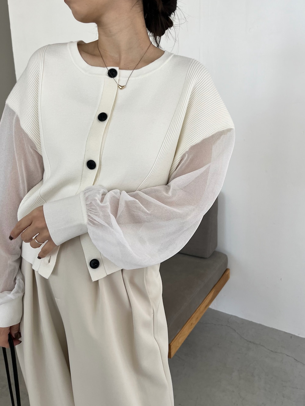 ホワイト系のニット/セーター、ホワイト系のその他パンツ、ブラック系のショルダーバッグを着用したレディースの冬コーディネートの3枚目の写真