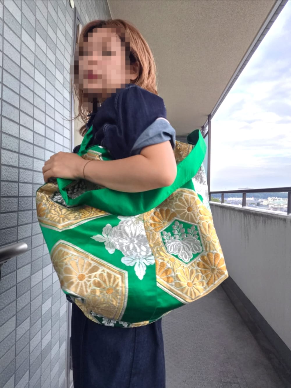 グリーン系のメッセンジャーバッグを着用したレディースの秋コーディネートの2枚目の写真