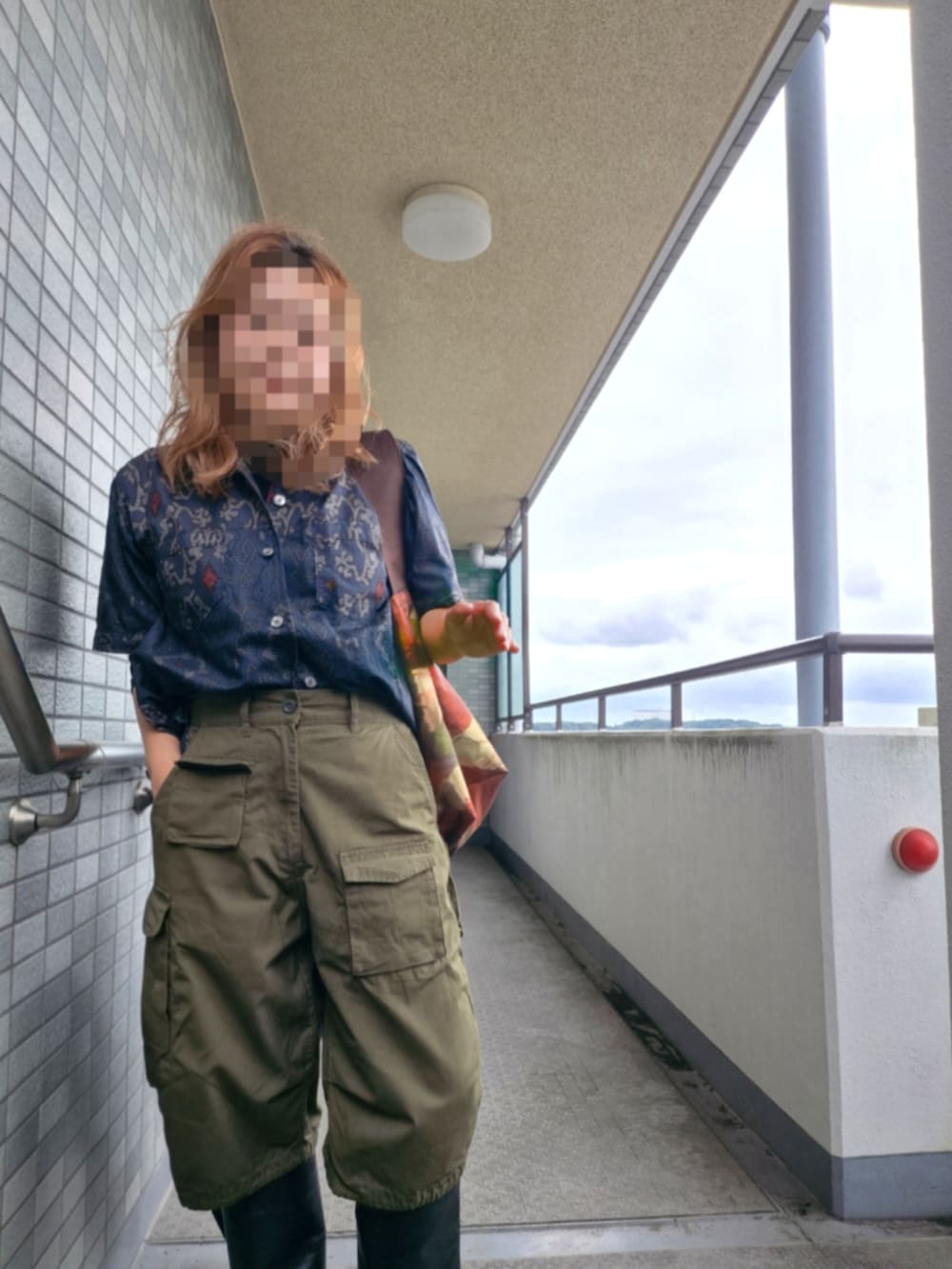 グリーン系のカーゴパンツ、ブルー系のシャツ/ブラウス、ブラウン系のショルダーバッグを着用したレディースの秋コーディネートの2枚目の写真