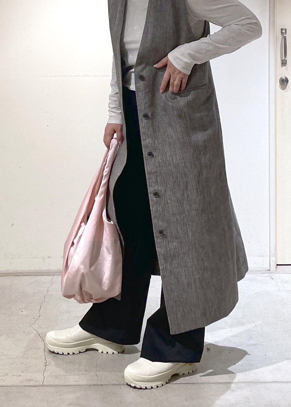 ブラック系のジャンパースカート、ブラック系のその他パンツ、ホワイト系のTシャツ/カットソーを着用したレディースの冬コーディネートの3枚目の写真