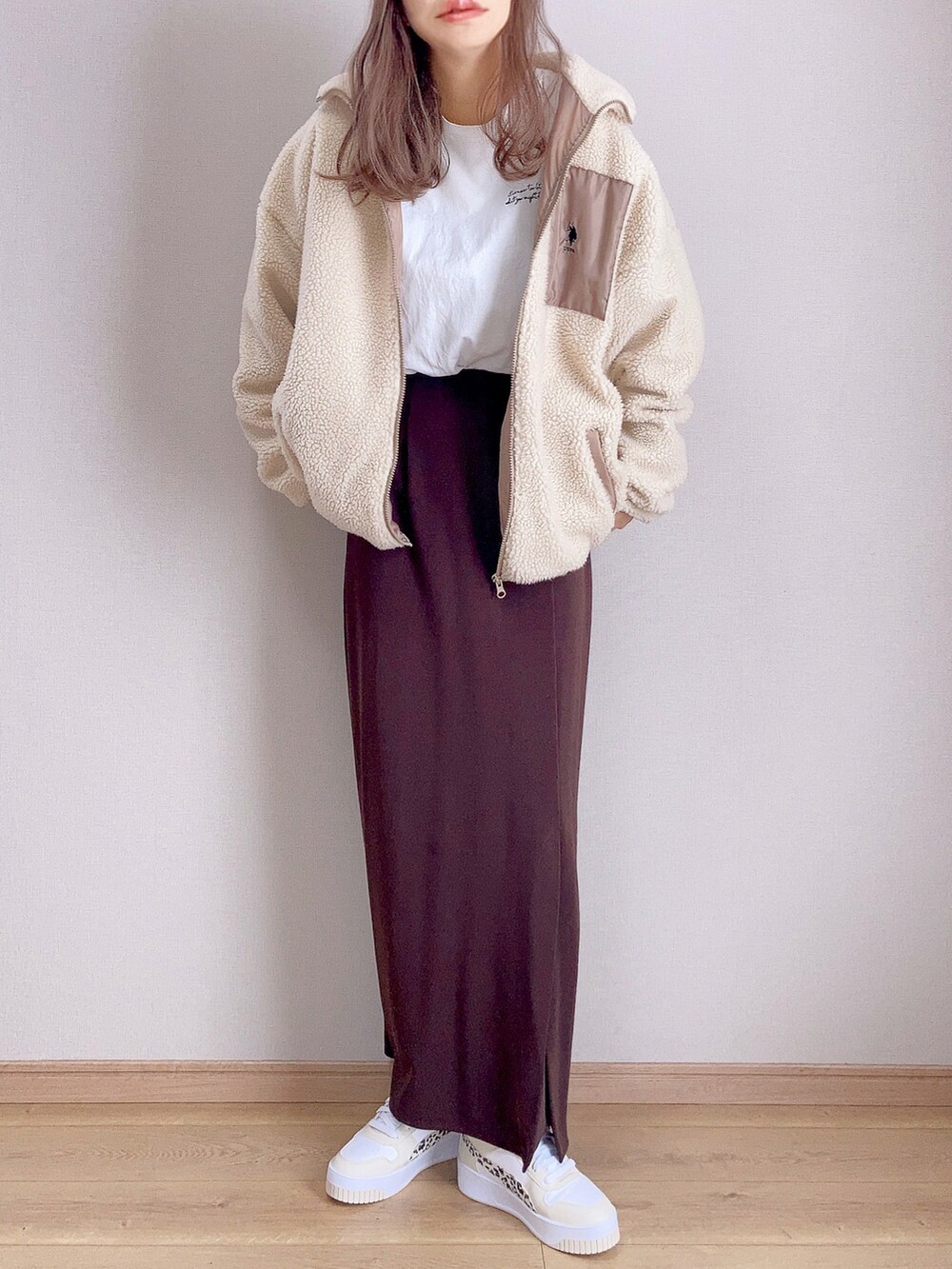 ベージュ系のブルゾン、ホワイト系のTシャツ/カットソー、ブラウン系のスカートを着用したレディースの秋コーディネートの2枚目の写真