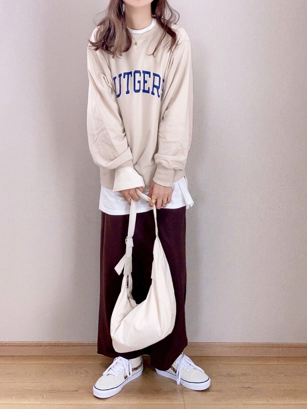 ホワイト系のスウェット、ブラウン系のスカート、ホワイト系のショルダーバッグを着用したレディースの秋コーディネートの3枚目の写真