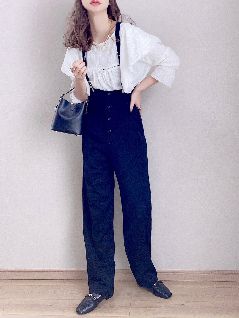 ホワイト系のシャツ/ブラウス、ブラック系のサロペット/オーバーオール、ブラック系のショルダーバッグを着用したレディースの冬コーディネートの2枚目の写真