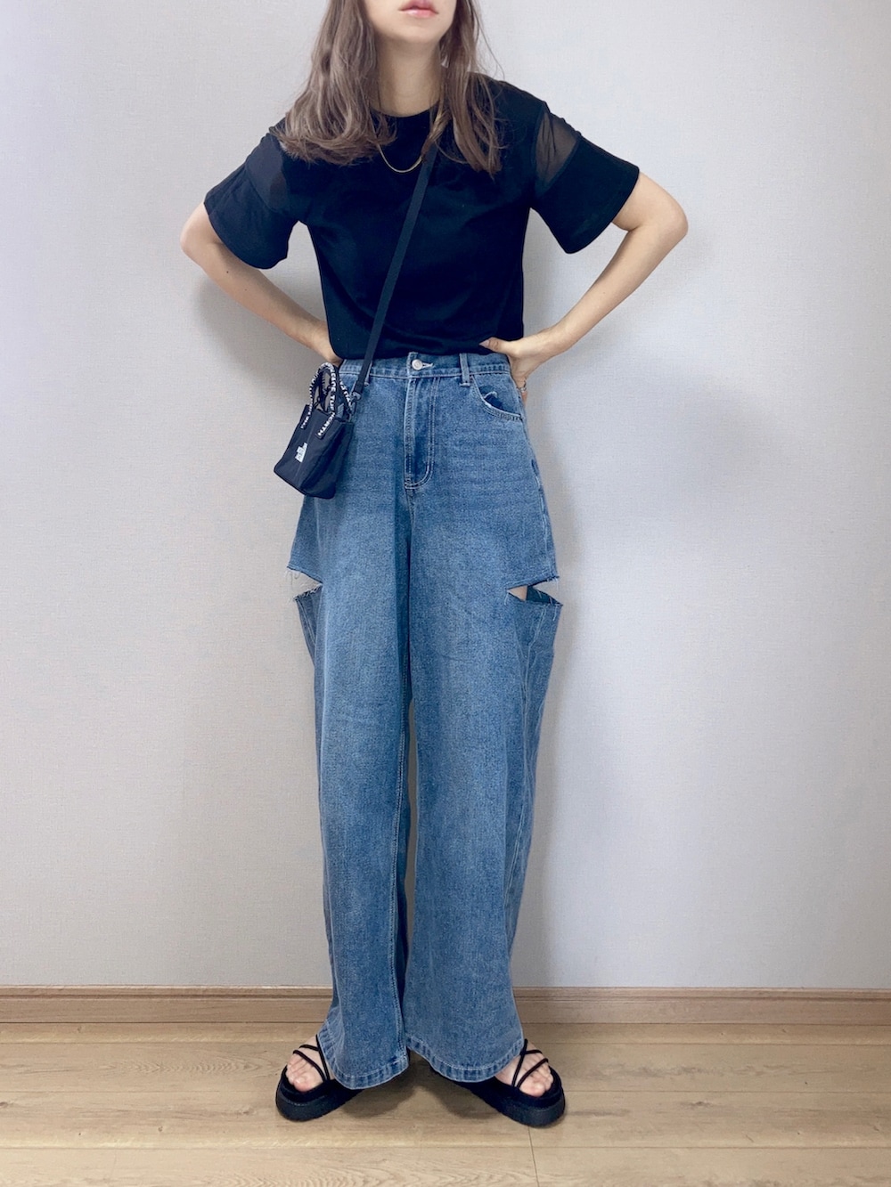 ブラック系のTシャツ/カットソー、ブルー系のデニムパンツ、ブラック系のショルダーバッグを着用したレディースの夏コーディネートの2枚目の写真