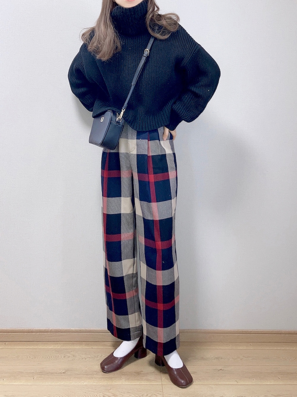 ブルー系のその他パンツ、ブラック系のショルダーバッグ、ブラック系のニット/セーターを着用したレディースの冬コーディネートの2枚目の写真