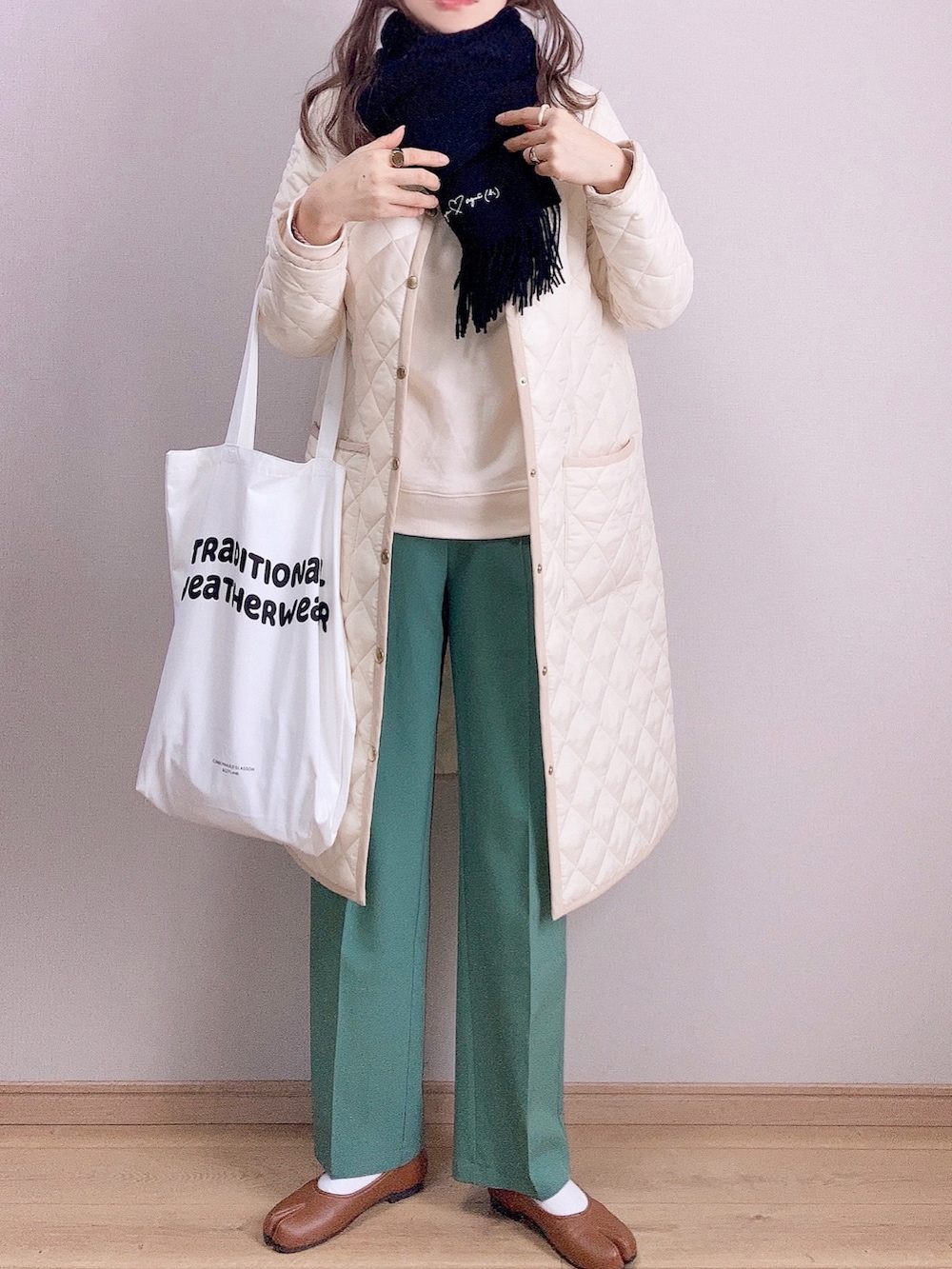 ホワイト系のその他アウター、ホワイト系のトートバッグ、ホワイト系のスウェットを着用したレディースの冬コーディネートの2枚目の写真