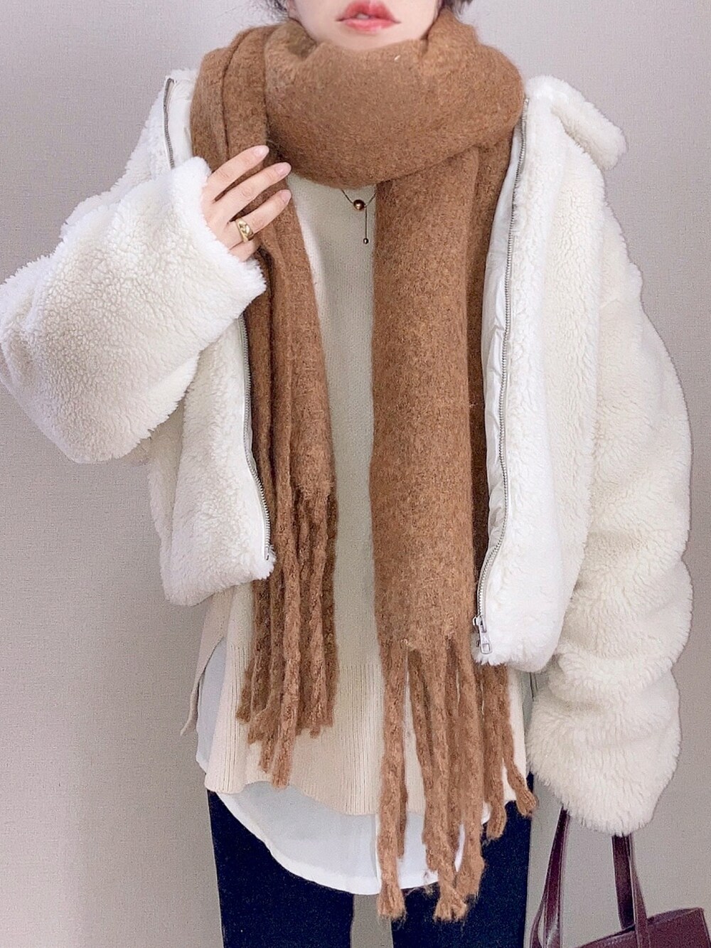 ホワイト系のその他アウター、ブラック系のデニムパンツ、その他のスニーカーを着用したレディースの秋コーディネートの3枚目の写真