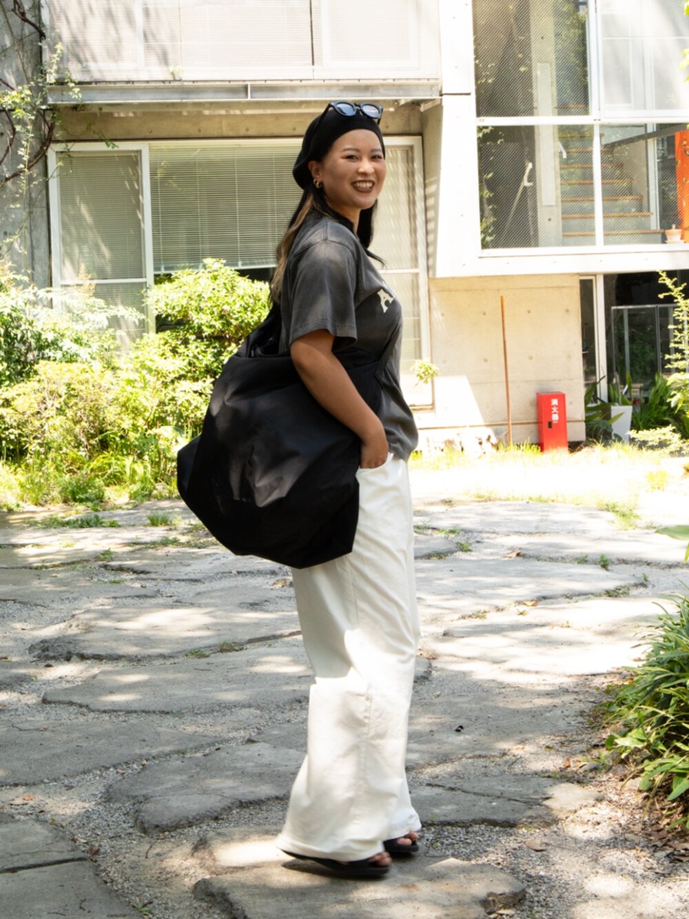 ブラック系のTシャツ/カットソー、ブラック系のショルダーバッグ、その他のサングラスを着用したレディースの夏コーディネートの2枚目の写真