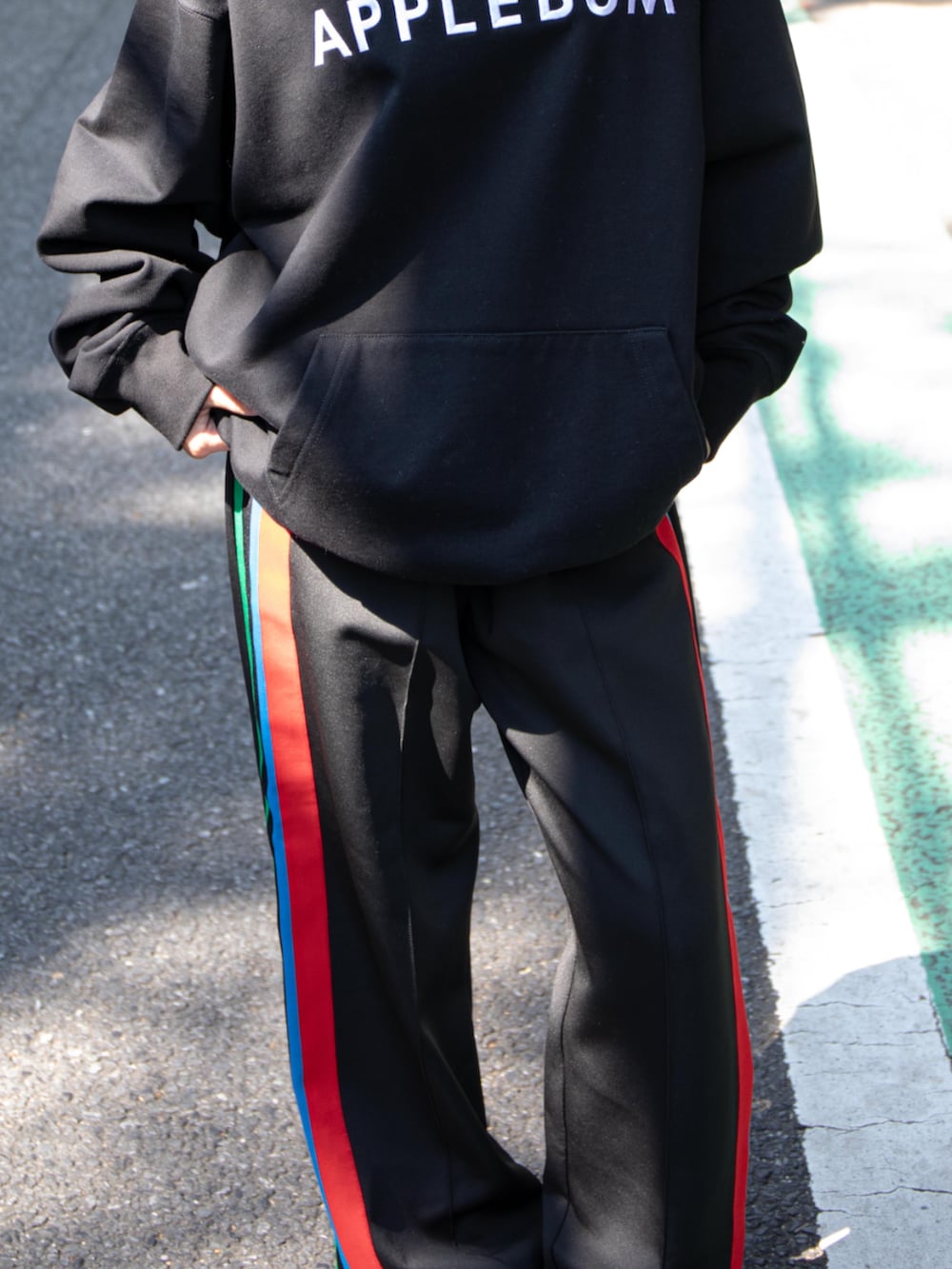 ブラック系のその他パンツ、ブラック系のパーカー、レッド系のキャップを着用したレディースの秋コーディネートの3枚目の写真