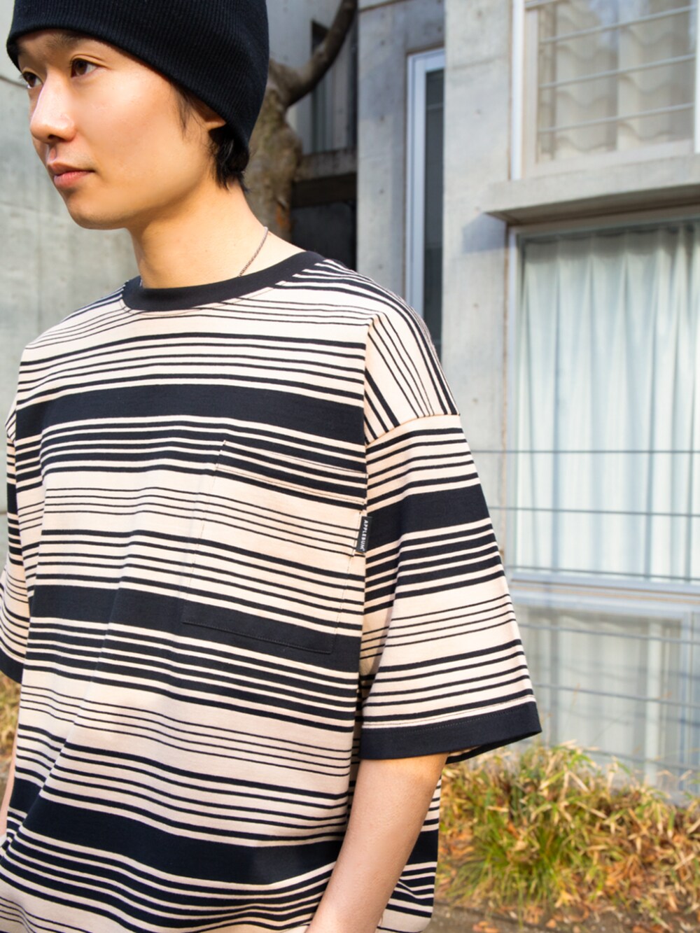 ブルー系のデニムパンツ、ベージュ系のTシャツ/カットソーを着用したメンズの夏コーディネートの2枚目の写真