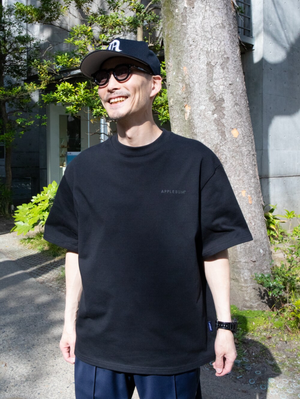 ブラック系のTシャツ/カットソー、ブラック系のキャップを着用したメンズの夏コーディネートの2枚目の写真