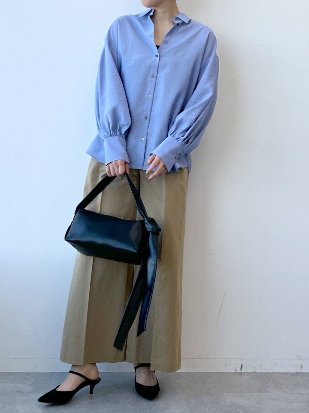 ブラック系のショルダーバッグ、ブラック系のサンダル、ブラウン系のチノパンツを着用したレディースの春コーディネートの4枚目の写真