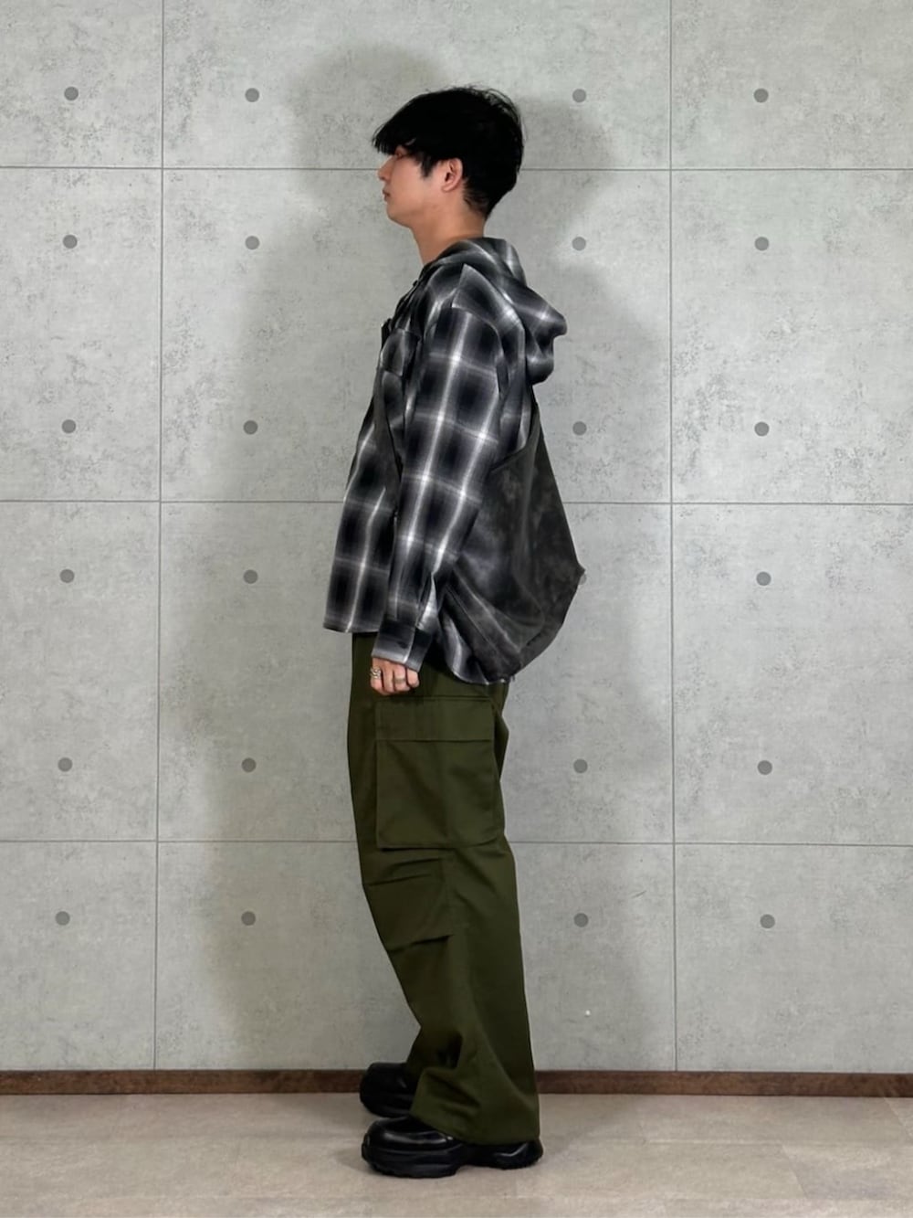 グレー系のショルダーバッグ、ブラック系のシャツ/ブラウス、グリーン系のカーゴパンツを着用したメンズの春コーディネートの2枚目の写真