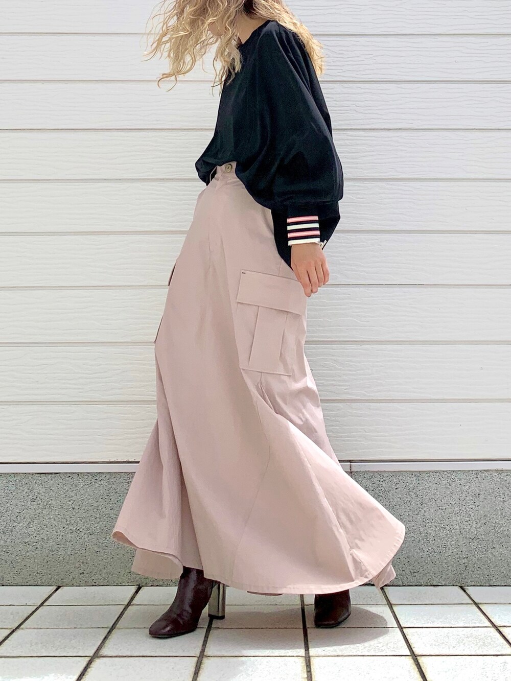 ブラック系のシャツ/ブラウス、ピンク系のスカート、ブラウン系のブーツを着用したレディースの夏コーディネートの2枚目の写真