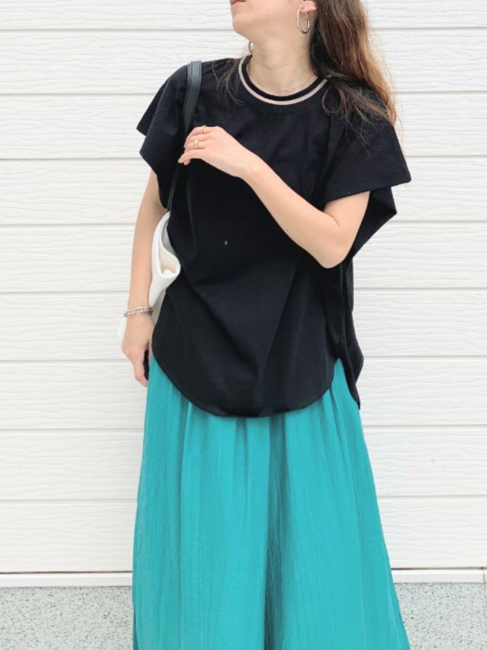 ホワイト系のトートバッグ、グリーン系のその他パンツ、ブラック系のTシャツ/カットソーを着用したレディースの夏コーディネートの3枚目の写真